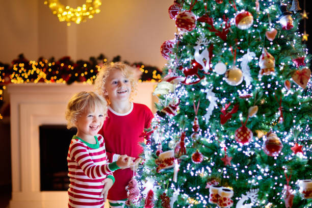 istock Child decorating Christmas tree. Kid on Xmas eve. 1809945601