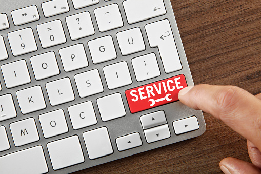 Man pushing Servicel Button on computer keyboard.