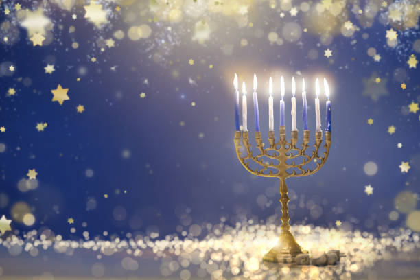 Happy Hanukkah. Candles lit in menorah.