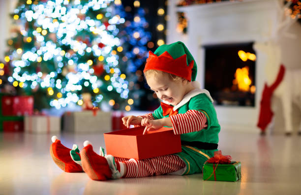 istock Kids at Christmas tree. Children open presents 1809951219