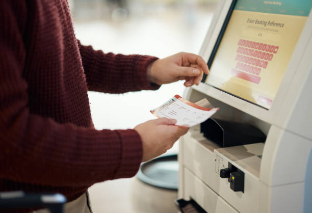 istock Hands, ticket and airport by self service for check in, registration or online boarding pass. Hand of traveler by terminal machine or kiosk for travel application, document or booking flight trip 1809953029