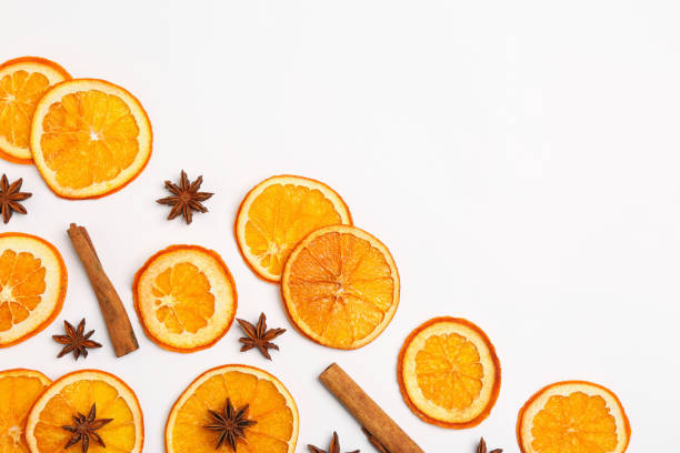 istock Flat lay composition with dry orange slices, anise stars and cinnamon sticks on white background. Space for text 1809960139