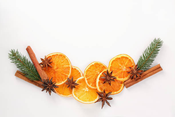 istock Flat lay composition with dry orange slices, anise stars and cinnamon sticks on white background. Space for text 1809960419