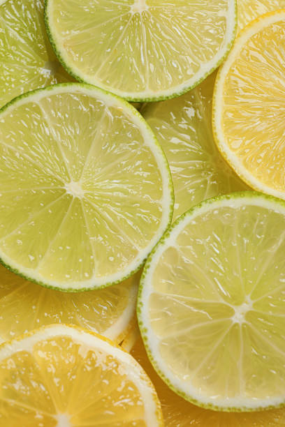 istock Slices of lemon and lime as background, top view 1809961248