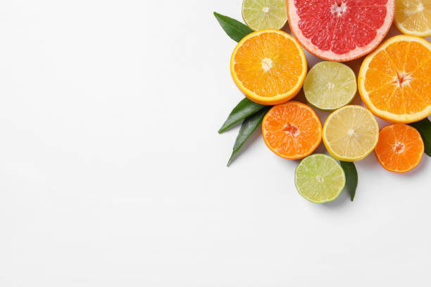 istock Different citrus fruits with fresh leaves on white background, top view. Space for text 1809962470