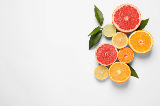 istock Different citrus fruits with fresh leaves on white background, top view. Space for text 1809962990