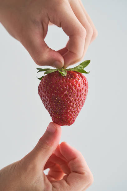 istock Anonymous person holding appetizing strawberry 1809966750