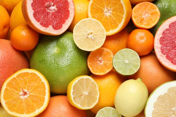 istock Different ripe citrus fruits as background, top view 1809967275
