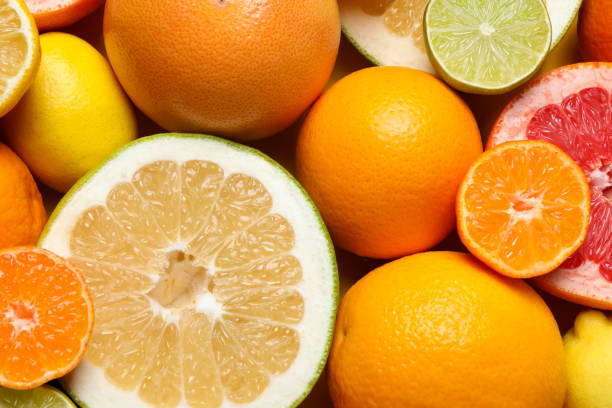istock Different ripe citrus fruits as background, top view 1809967834