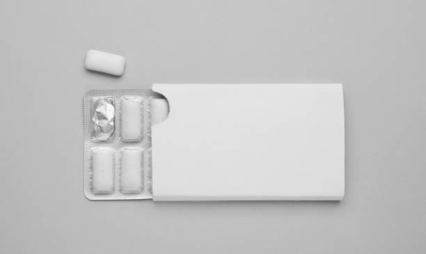 Blister with chewing gums on grey background, top view