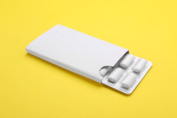 Blister with chewing gums on yellow background