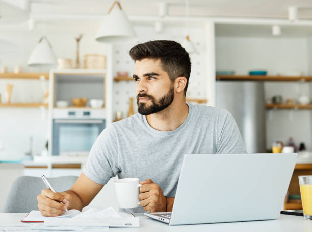 istock laptop man computer home technology young  lifestyle business internet study indoor male reading 1809977370