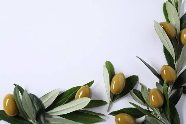 istock Fresh green olives and leaves on white background, flat lay. Space for text 1809977713