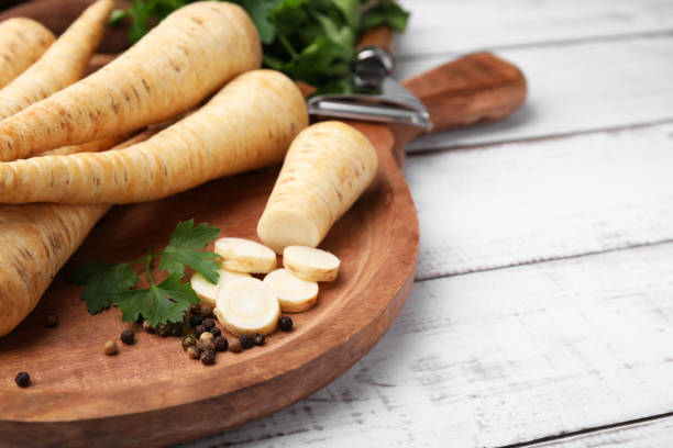 istock Raw parsley roots and fresh herb on white wooden table, closeup. Space for text 1809979121