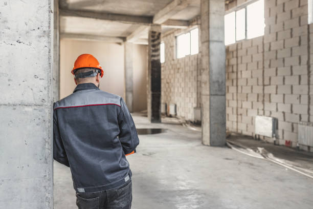 istock A construction worker in a helmet stands with his back to the camera, leaning on a reinforced concrete structure, thinking about something, copy space 1809989484