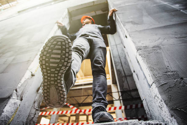 istock Builder man near an unfenced dangerous opening at a height at a construction site. Violation of safety regulations at a construction site 1809990027