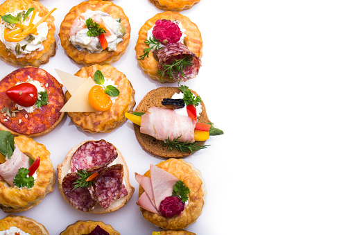 many different canapes on a white background