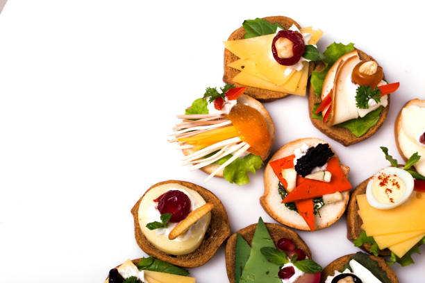 many different canapes on a white background - tablesetting imagens e fotografias de stock
