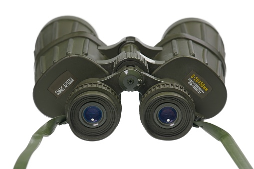 Old green camouflage binoculars on a white background