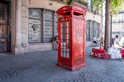 Vintage red phone booth at Liberty Square and Av. dos Aliados, Porto, Portugal. Praça da Liberdade e Av. dos Aliados.