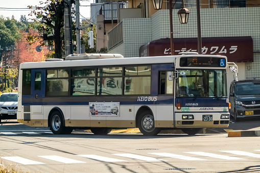 Tama New Town, Tokyo, Japan. Nov 20, 2023. A Keio Bus Minami vehicle diligently adhering to its designated route under optimal weather conditions on a sunlit day.