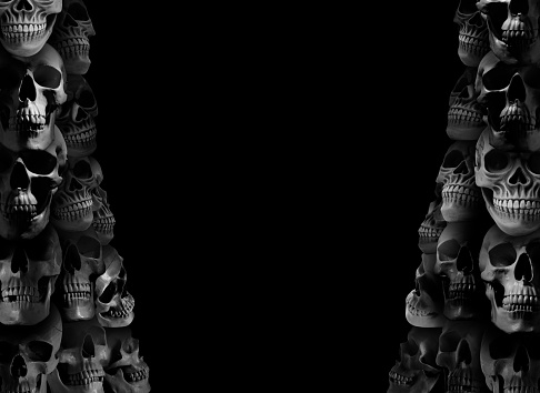 Many scary human skulls on black background, space for text