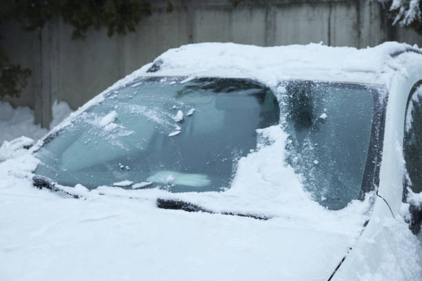 istock Car windshield with wiper blades cleaned from snow outdoors on winter day 1810055987