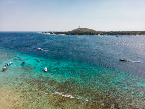 Tropical sandy beach with turquoise ocean drone aerial landscape at Gili islands in Lombok, Indonesia