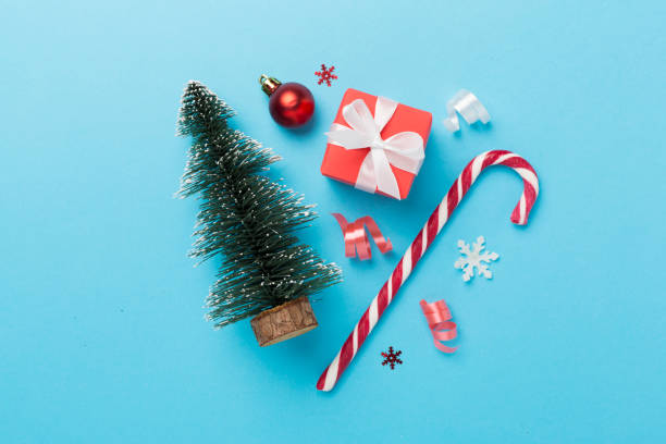 istock Miniature christmas tree with gift box and decor on color background 1810078443