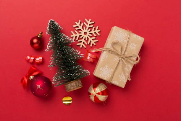 istock Miniature christmas tree with gift box and decor on color background 1810078455