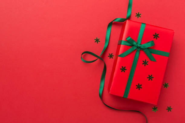istock Creative handmade christmas gift box with decor on color background, top view 1810078464