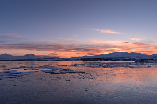 Arctic sunset over icy sea water