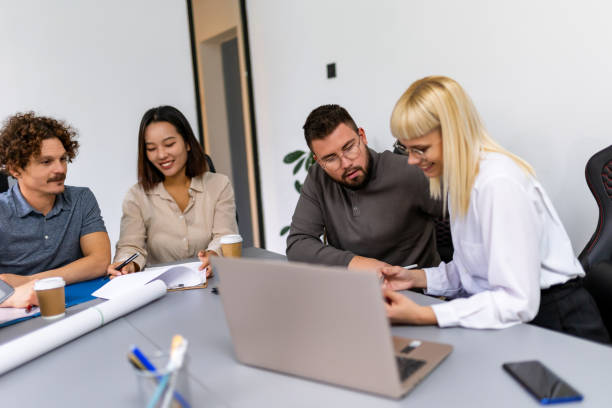 istock Group of young entrepreneurs working on a computer and plans in the office. 1810083977