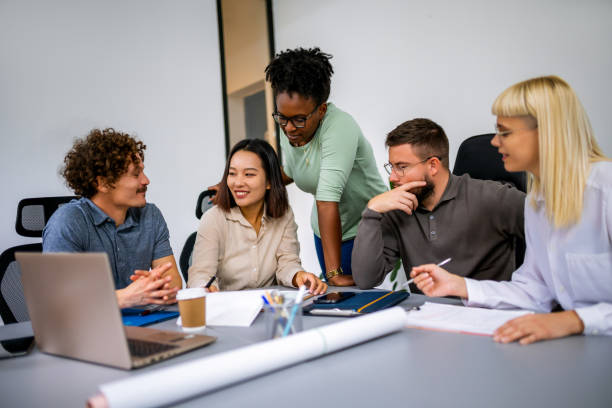 istock Group of young entrepreneurs working on a computer and plans in the office. 1810083989