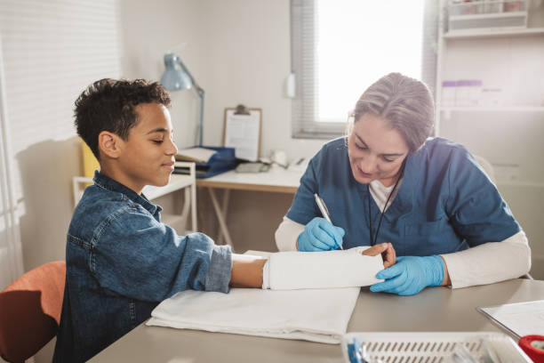 istock Child with arm injury at doctors office 1810094242