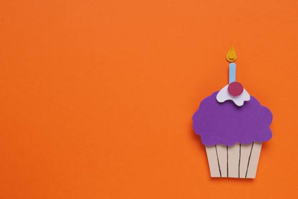 istock Birthday party. Paper cupcake on orange background, top view with space for text 1810099617