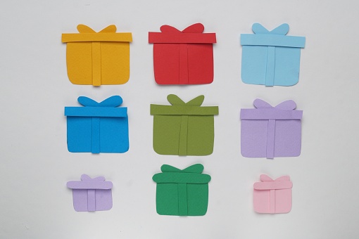Colorful paper gift boxes on white background, flat lay