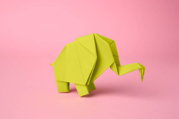 istock Origami art. Paper elephant on pink background 1810102295
