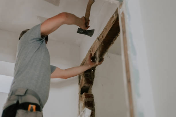 istock A young Caucasian male builder clears a doorway using a crowbar. 1810118775
