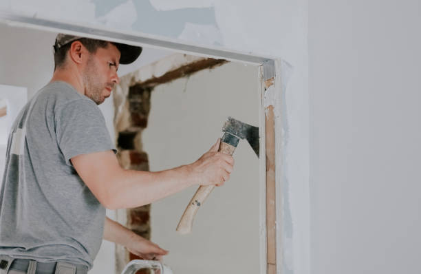 istock A young Caucasian male builder is working with an ax in a doorway. 1810118789