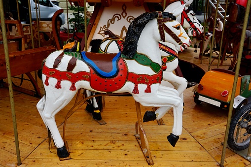 Children's carousel with horses. Christmas market in Germany. Toy horses on a carousel. Entertainment for children.