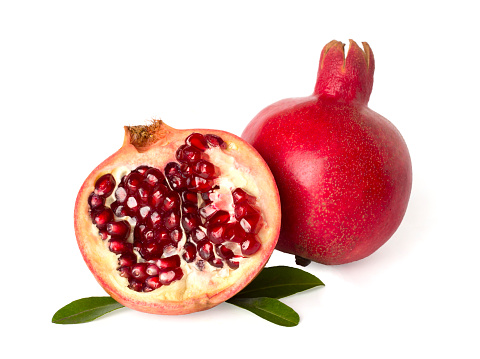 Pomegranates with leaves isolated on white
