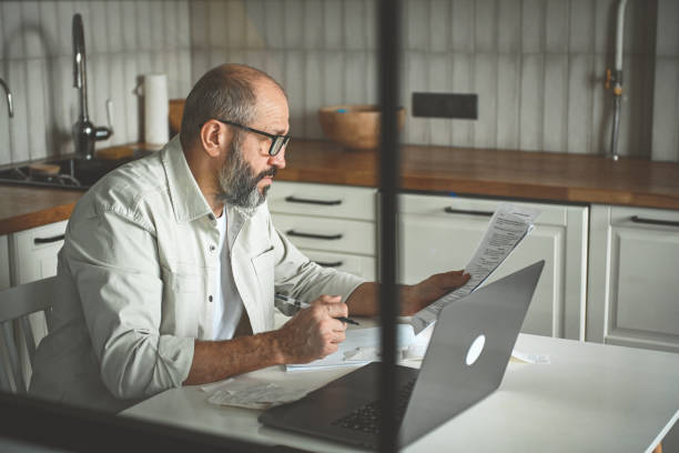 Mature adult man working at home stock photo