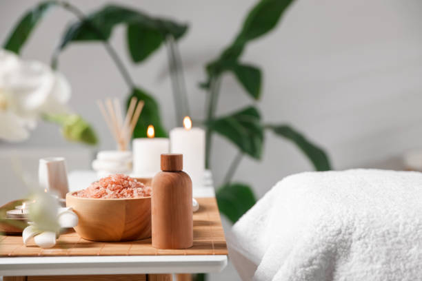 istock Cosmetic products and candles on table in spa salon, space for text 1810146109