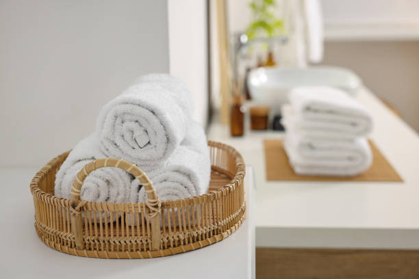 istock Rolled soft towels on white table in bathroom. Space for text 1810146647