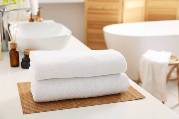 istock Stacked soft towels on white table in bathroom 1810147157