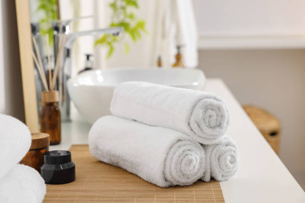istock Rolled soft towels on white table in bathroom 1810147170