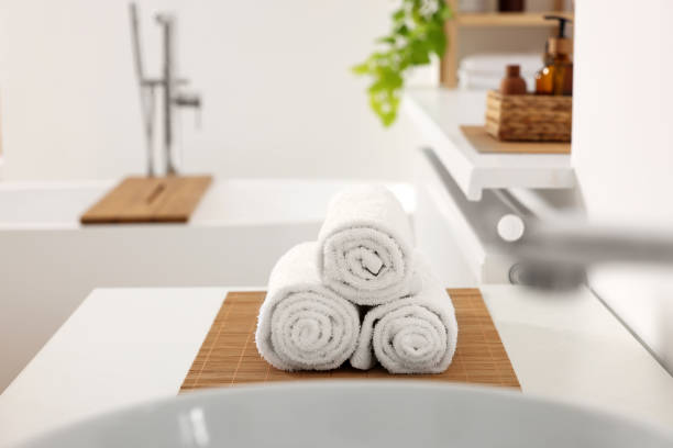 istock Rolled soft towels on white table in bathroom 1810147686