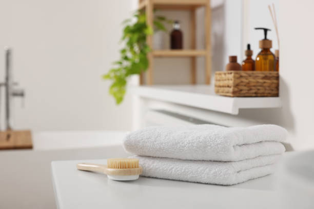 istock Stacked soft towels on white table in bathroom. Space for text 1810147692