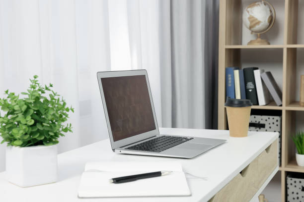 istock Workplace with modern laptop on desk at home 1810148781